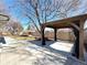 Backyard featuring a covered patio with curtains and decorative brick planter at 6556 Wolff St, Arvada, CO 80003