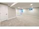 Finished basement featuring neutral colored carpet, recessed lighting, and white painted door at 6556 Wolff St, Arvada, CO 80003