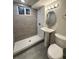 Updated bathroom featuring a tile shower, sleek pedestal sink, and modern fixtures at 6556 Wolff St, Arvada, CO 80003