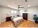 Comfortable bedroom with ceiling fan, hardwood floors, and a neutral color palette at 6556 Wolff St, Arvada, CO 80003