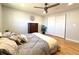 Bedroom featuring hardwood floors, closet, dresser, and a comfy bed at 6556 Wolff St, Arvada, CO 80003