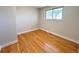 Empty bedroom features hardwood floors, a window, and natural light at 6556 Wolff St, Arvada, CO 80003