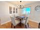 Cozy dining room with a modern chandelier, neutral wall art, and a large window view at 6556 Wolff St, Arvada, CO 80003