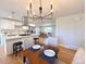 Inviting dining area featuring modern lighting and neutral decor open to an updated kitchen space at 6556 Wolff St, Arvada, CO 80003