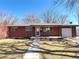 Charming brick home with a well-maintained lawn, walkway, and a single car garage at 6556 Wolff St, Arvada, CO 80003