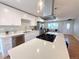 Beautiful, light-filled kitchen with a quartz island, stainless steel appliances, and sleek white cabinetry at 6556 Wolff St, Arvada, CO 80003