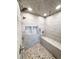 Modern tiled walk-in shower with dual shower heads, built-in niche, and seating at 6556 Wolff St, Arvada, CO 80003