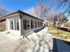 Sun room addition featuring multiple windows, a concrete walkway, and access to the backyard at 6556 Wolff St, Arvada, CO 80003