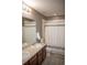 Well-lit bathroom with dual sinks, tub and shower combination, and modern fixtures at 7603 Sabino Ln, Castle Rock, CO 80108
