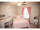 Inviting bedroom with pink accents, vanity, and cozy decor at 7603 Sabino Ln, Castle Rock, CO 80108