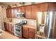 Kitchen area with granite countertops, stainless steel appliances and dark wood cabinets at 7603 Sabino Ln, Castle Rock, CO 80108