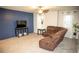 Comfortable living room with plush seating, ceiling fan, and modern accent wall at 7603 Sabino Ln, Castle Rock, CO 80108