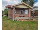 Charming brick home with a cozy front porch and well-maintained landscaping at 2034 S Lincoln St, Denver, CO 80210