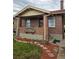 Charming brick home with a cozy front porch and well-maintained landscaping at 2034 S Lincoln St, Denver, CO 80210