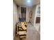 Hallway with gray carpet leads to bathroom and laundry room at 2034 S Lincoln St, Denver, CO 80210