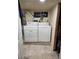 Laundry room with a stacked washer and dryer at 2034 S Lincoln St, Denver, CO 80210