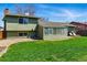 This spacious backyard features a patio, well-kept lawn, sunroom, and convenient access from the house at 4581 S Garrison St, Littleton, CO 80123