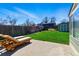 Landscaped backyard featuring a well-maintained lawn, shed, wood fence, and patio area with lounge chairs at 4581 S Garrison St, Littleton, CO 80123
