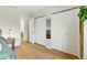 Bright bedroom includes white closets, light hardwood floors, and a serene atmosphere for relaxation and restful nights at 4581 S Garrison St, Littleton, CO 80123