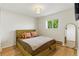 Cozy bedroom with hardwood floors, accent pillows, natural light, and ceiling fan at 4581 S Garrison St, Littleton, CO 80123