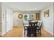 Cozy dining room featuring hardwood floors, and warm natural light from a large window at 4581 S Garrison St, Littleton, CO 80123