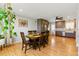 Open concept view of the dining area next to an updated kitchen with modern appliances at 4581 S Garrison St, Littleton, CO 80123