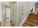 Hallway with wooden stairs leading up to a partial view of the dining room table and chairs at 4581 S Garrison St, Littleton, CO 80123