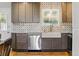 Beautifully remodeled kitchen with granite countertops, stainless steel appliances and large farmhouse sink at 4581 S Garrison St, Littleton, CO 80123