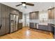 Remodeled kitchen with stainless steel refrigerator and appliances and a farm sink at 4581 S Garrison St, Littleton, CO 80123