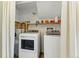 Laundry room with front load washer and dryer and added shelving for storage at 4581 S Garrison St, Littleton, CO 80123