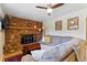 Cozy living room featuring a brick fireplace, wood mantle, comfortable seating, and stylish decor at 4581 S Garrison St, Littleton, CO 80123