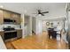 Open concept space includes dining area next to kitchen with stainless steel appliances and hardwood floors at 4581 S Garrison St, Littleton, CO 80123