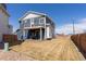 Spacious backyard with a patio, second story deck, modern fence and a well-maintained lawn at 16382 E 111Th Dr, Commerce City, CO 80022