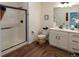 Bright bathroom with white vanity, modern fixtures, and a glass-enclosed shower showcasing contemporary design at 16382 E 111Th Dr, Commerce City, CO 80022