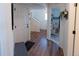 Inviting foyer with hardwood floors, a coat rack, and a view of the staircase, creating a welcoming entrance at 16382 E 111Th Dr, Commerce City, CO 80022