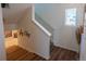 Upstairs hallway features a view to the right, with a small window and clean neutral design at 16382 E 111Th Dr, Commerce City, CO 80022
