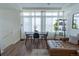 Open floor plan showcasing a dining table, floor-to-ceiling windows, and a stylish leather sofa in the living area at 16382 E 111Th Dr, Commerce City, CO 80022