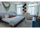Serene bedroom featuring a cozy bed, modern decor, and soft natural light streaming through the windows at 16382 E 111Th Dr, Commerce City, CO 80022