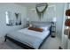 Stylish bedroom featuring a comfortable bed, modern decor, and soft lighting from unique lamp fixtures at 16382 E 111Th Dr, Commerce City, CO 80022