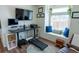 Bright home office with a large window, modern desk, and comfortable seating, creating a productive workspace at 16382 E 111Th Dr, Commerce City, CO 80022
