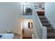 Carpeted stairs with white railing lead to the upper level, offering a view of the living area below at 16382 E 111Th Dr, Commerce City, CO 80022