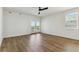 Spacious bedroom with double doors, hardwood floors, a ceiling fan, and lots of natural light at 42982 Colonial Trl, Elizabeth, CO 80107