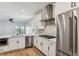 Bright modern kitchen with stainless steel appliances, white cabinets, and an island sink with black fixtures at 42982 Colonial Trl, Elizabeth, CO 80107