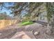 Expansive backyard with lush green lawn, rock beds, stone pathway, and new wooden fence at 4 Meadowlark Ln, Littleton, CO 80123