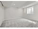 Large and bright unfinished basement space features a window and new carpet at 4 Meadowlark Ln, Littleton, CO 80123