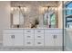 Modern bathroom featuring a double vanity, striking mirrors, and bright lighting at 4 Meadowlark Ln, Littleton, CO 80123