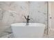 Luxurious bathroom featuring a soaking tub, rainfall shower, and elegant tile work at 4 Meadowlark Ln, Littleton, CO 80123