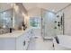 Bathroom with double sinks, mosaic wall, luxurious shower, and soaking tub at 4 Meadowlark Ln, Littleton, CO 80123
