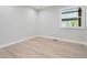 Clean and simple bedroom with hardwood floors and natural light from the window at 4 Meadowlark Ln, Littleton, CO 80123