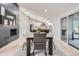 Dining area featuring a modern fireplace and seamless flow into the open kitchen and living areas at 4 Meadowlark Ln, Littleton, CO 80123